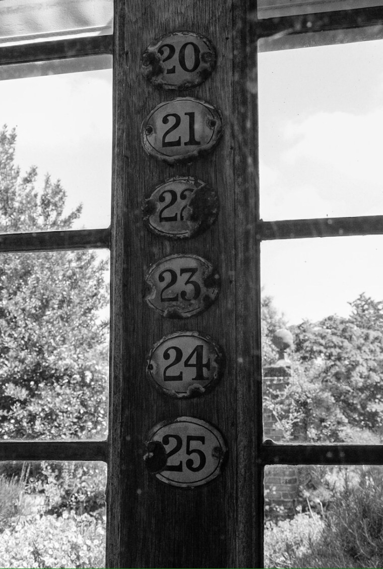 Little Hall, Lavenham. Abstract digital photograph of old door numbers.
