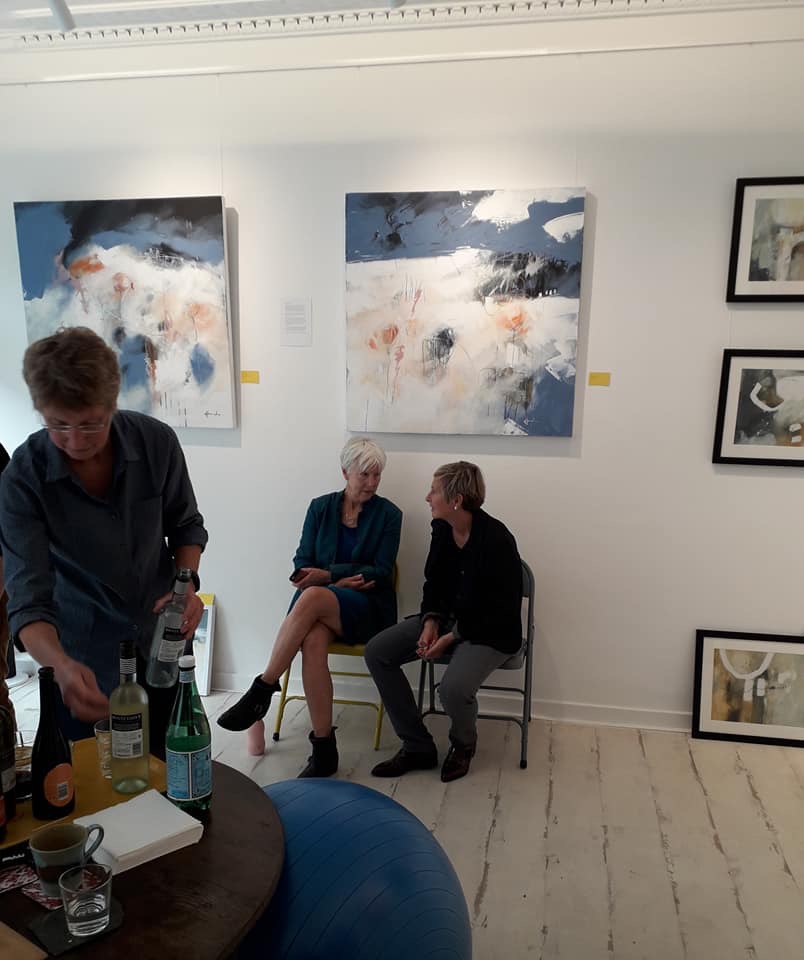 Artist Ruth McCabe chats with Gallery owner Susie Turner in front of my wall of work.